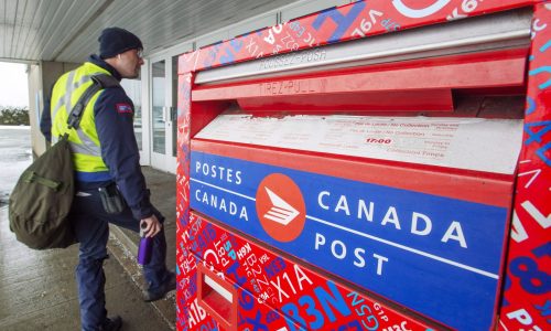 Canada Post workers return to work after the government ordered them to end their rotating strike Tuesday, November 27, 2018 in Montreal. THE CANADIAN PRESS/Ryan Remiorz